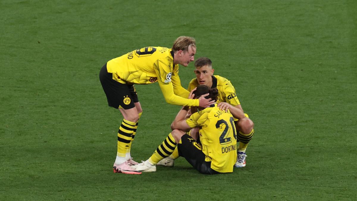 Borussia Dortmund players console each other